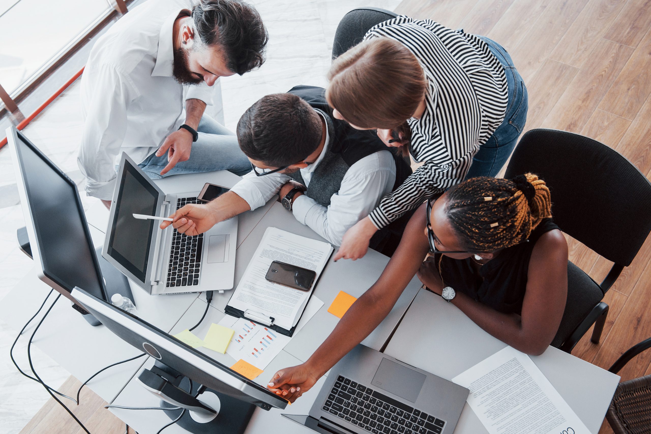 A group of multinational busy people working in the office. Height view